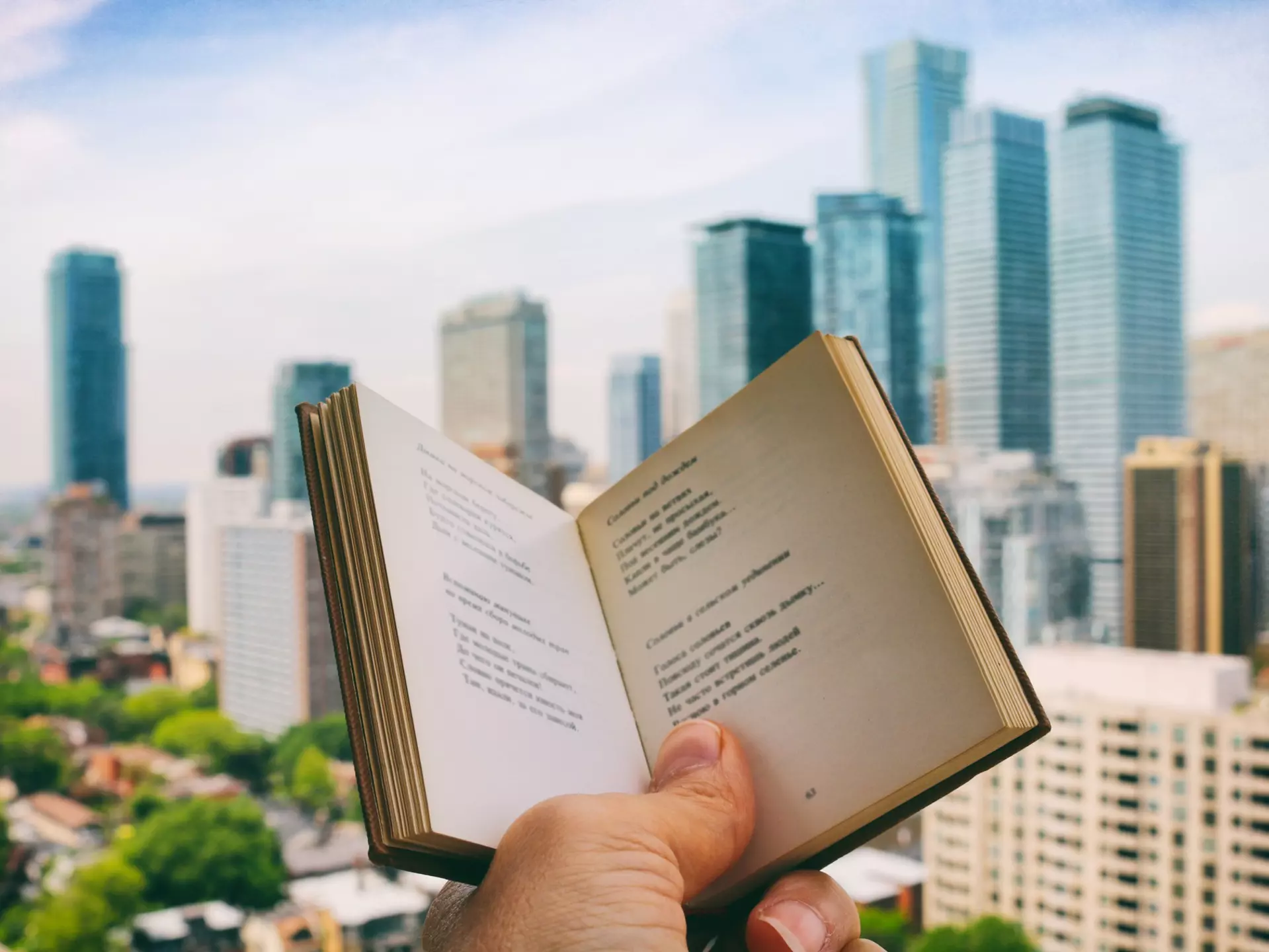Holding the open book, enjoying reading poetry, while on the rooftop patio with the view of the city life in the background. Part of 'Reading The Book' Series. (Creative Brief - Digital Wellbeing)
1159934929