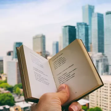 Holding the open book, enjoying reading poetry, while on the rooftop patio with the view of the city life in the background. Part of 'Reading The Book' Series. (Creative Brief - Digital Wellbeing)
1159934929