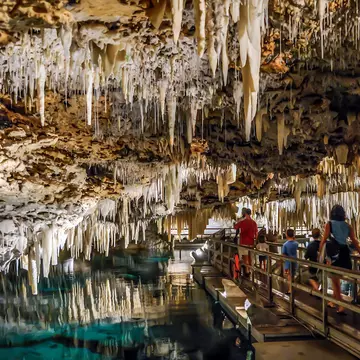 People walking under the stalactites of Bermuda's Crystal Cave