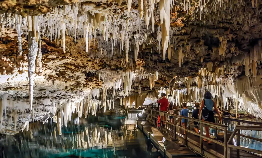 People walking under the stalactites of Bermuda's Crystal Cave