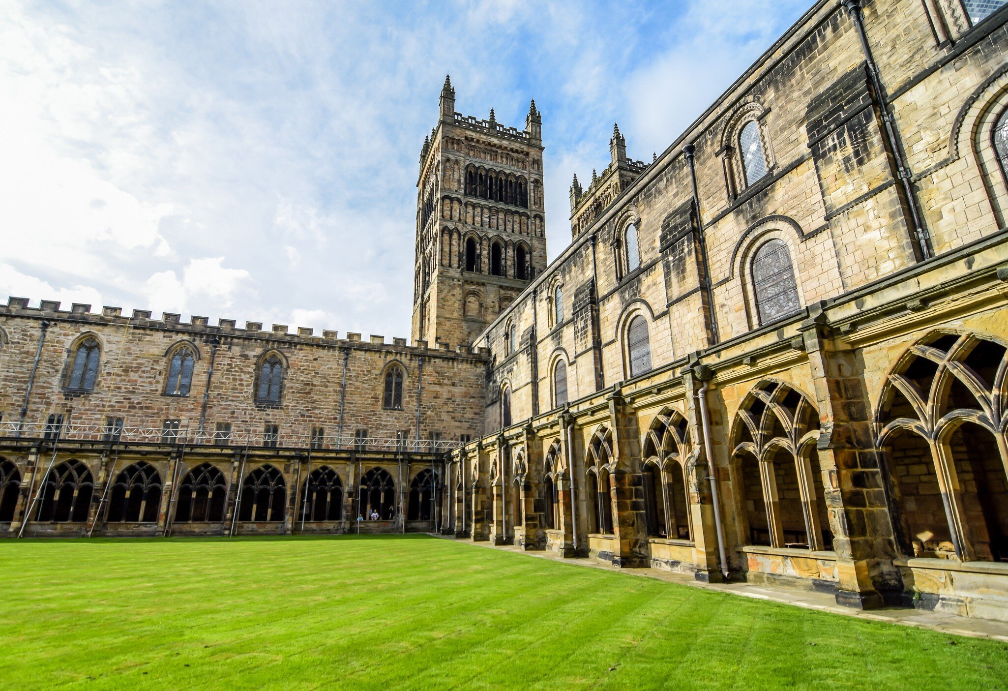 Rounded stone arches and a rib-vaulted ceiling along the nave of Durham Cathedral