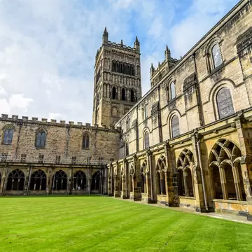 Rounded stone arches and a rib-vaulted ceiling along the nave of Durham Cathedral