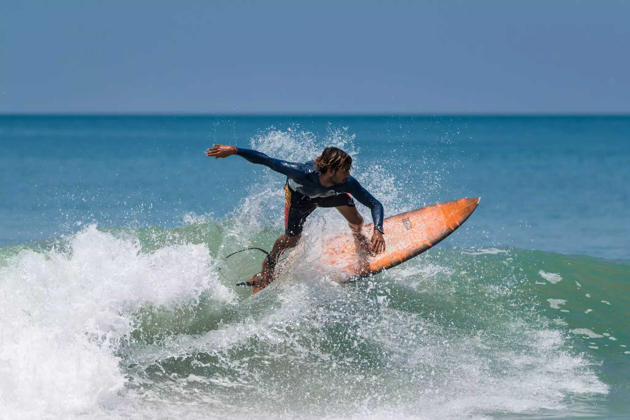 A surfer on the beach at Varkala in Kerala, India.