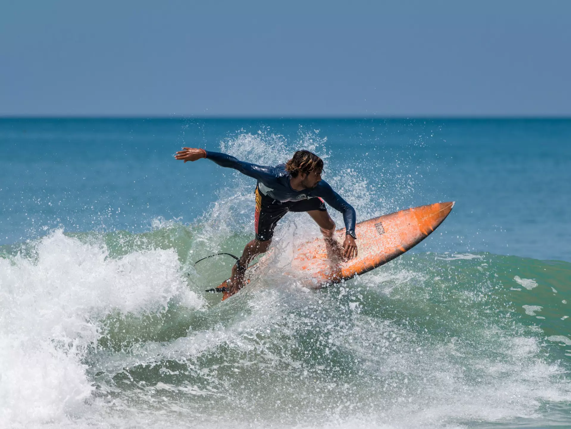 A surfer on the beach at Varkala in Kerala, India.