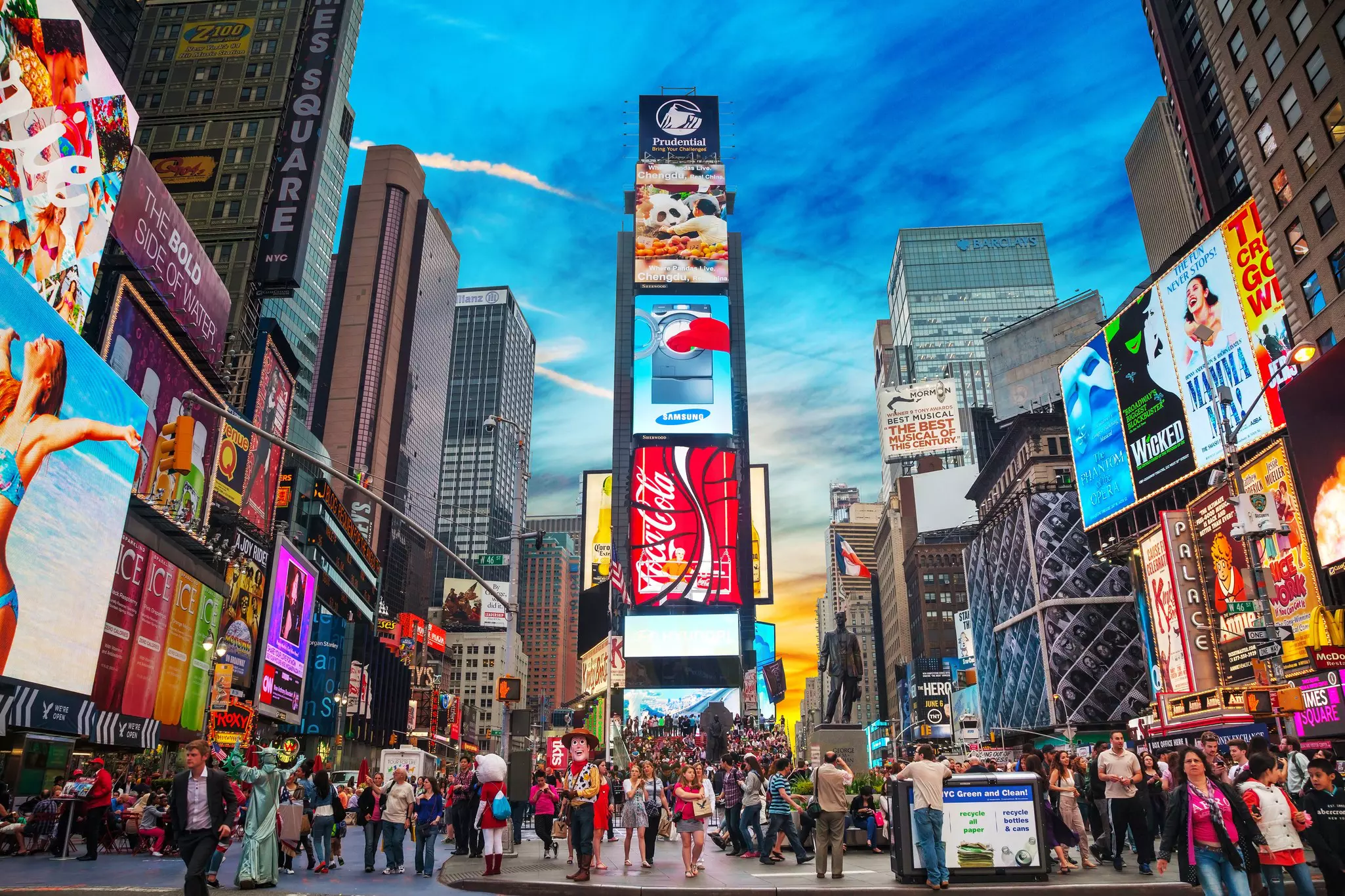 Crowds of tourists beneath the colorful billboards in Times Square, NYC.