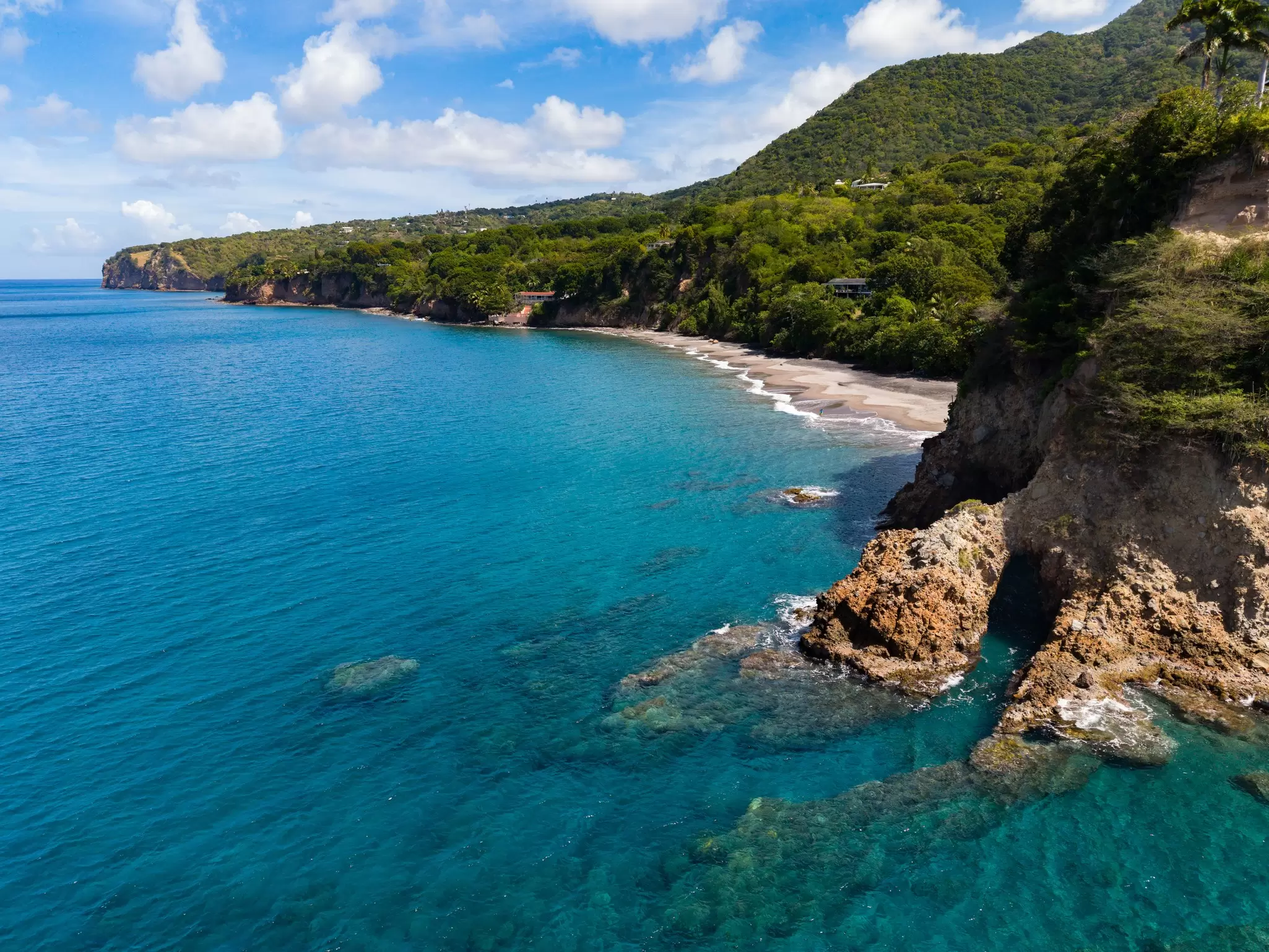 An aerial image looking northward along the western coastline of Montserrat, with Woodlands Beach on the bottom right.