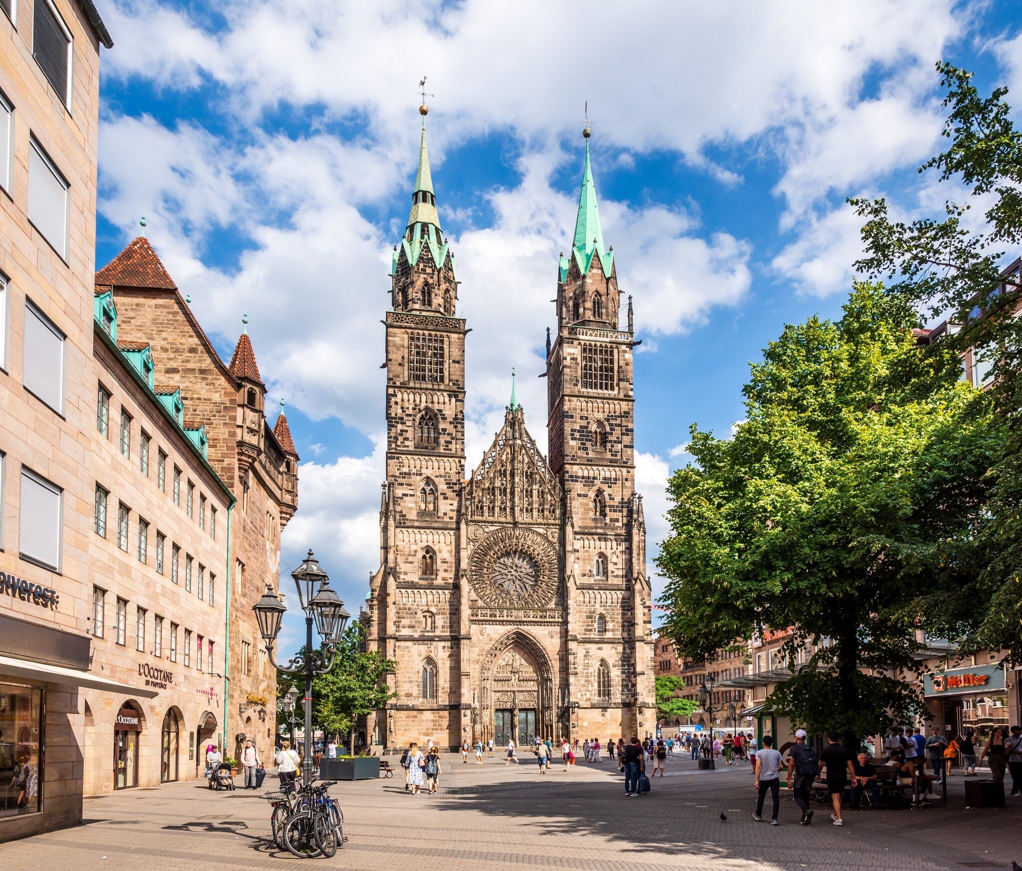 West facade of St. Lorenz church (Lorenzkirche) dominated by the two towers with a sharp towering West portal doorway and a 9-meter rose window. Nuremberg, Germany.