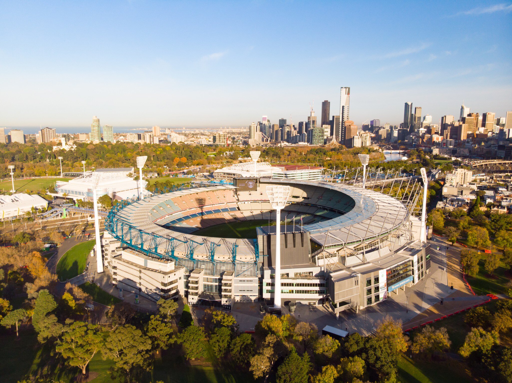 Aerial view of Melbourne's famous skyline with the Melbourne Cricket Ground stadium in the foreground on a cool autumn morning in Australia.