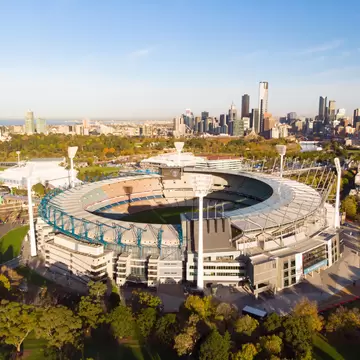 Aerial view of Melbourne's famous skyline with the Melbourne Cricket Ground stadium in the foreground on a cool autumn morning in Australia.