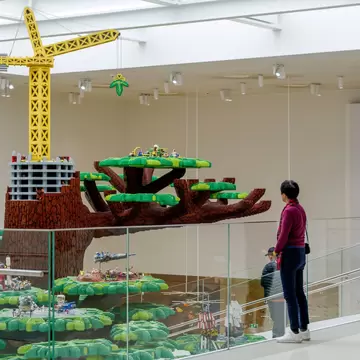  Interior view and selective focus at lego tree and various theme of lego set on the tree, inside the atrium between staircase at Lego House. Billund, Denmark.