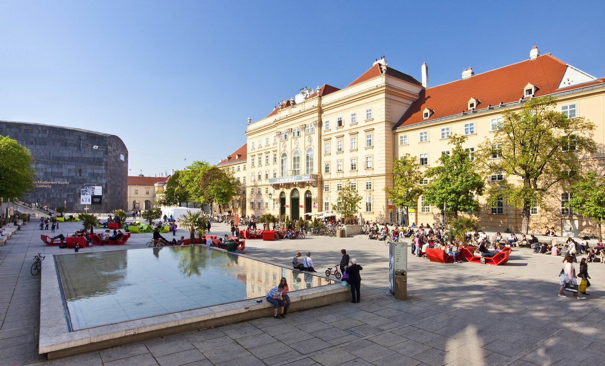VIENNA, AUSTRIA - APRIL 19: Many people enjoy a sunny afternoon at the Museumsquartier on April 19, 2011 in Vienna. It is the eighth largest cultural area in the world and a very important for Vienna; Shutterstock ID 202273378; Your name (First / ...