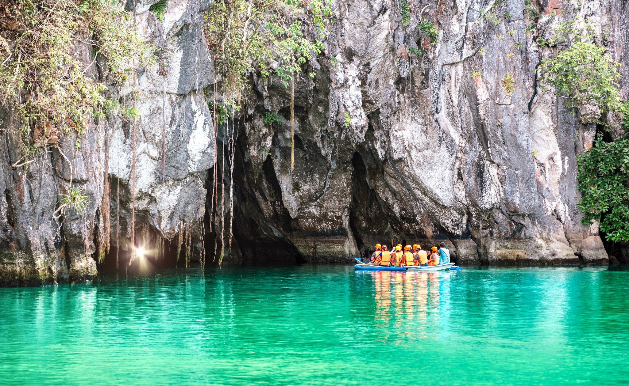 Cave entrance of Puerto Princesa subterranean underground river with longtail boat - Wanderlust travel concept at Palawan exclusive Philippine destination - Modified unrecognizable people; Puerto Princesa Subterranean River National Park, Puerto P...