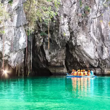 Cave entrance of Puerto Princesa subterranean underground river with longtail boat - Wanderlust travel concept at Palawan exclusive Philippine destination - Modified unrecognizable people; Puerto Princesa Subterranean River National Park, Puerto P...