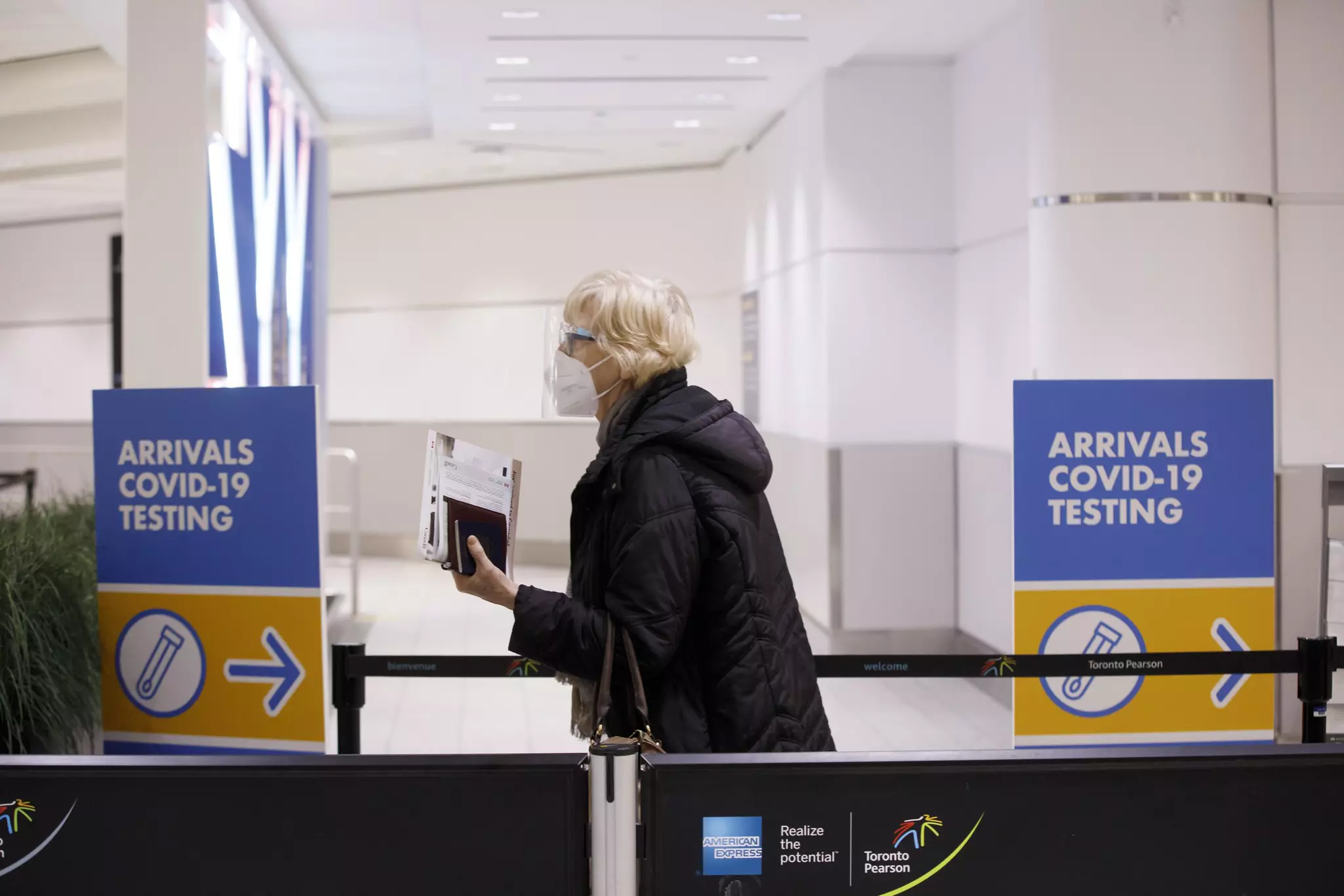Travelers arrive at the Pearson International Airport in Toronto, Canada, on March 26, 2020. Canada imposed a 14-day mandatory self-isolation rule for any traveler returning to Canada.