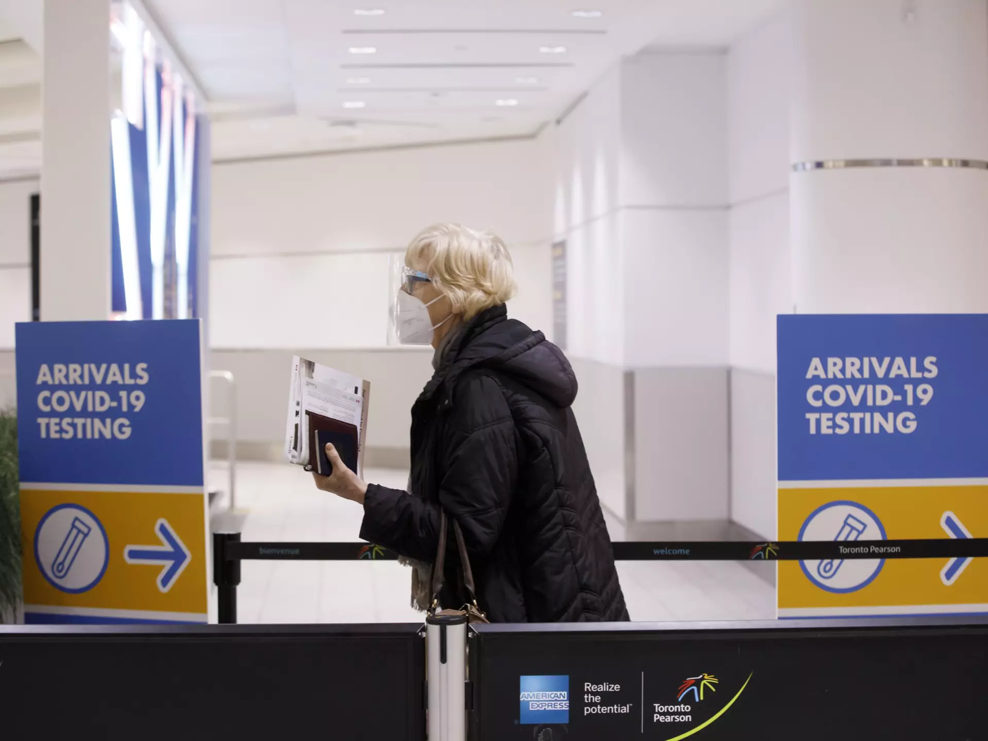 Travelers arrive at the Pearson International Airport in Toronto, Canada, on March 26, 2020. Canada imposed a 14-day mandatory self-isolation rule for any traveler returning to Canada.