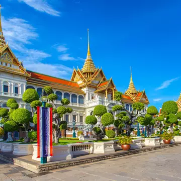 The Grand Palace and Wat Phra Kaew beneath a blue sky in Bangkok, Thailand