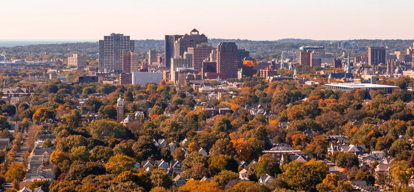 View of a city skyline surrounded by fall foliage