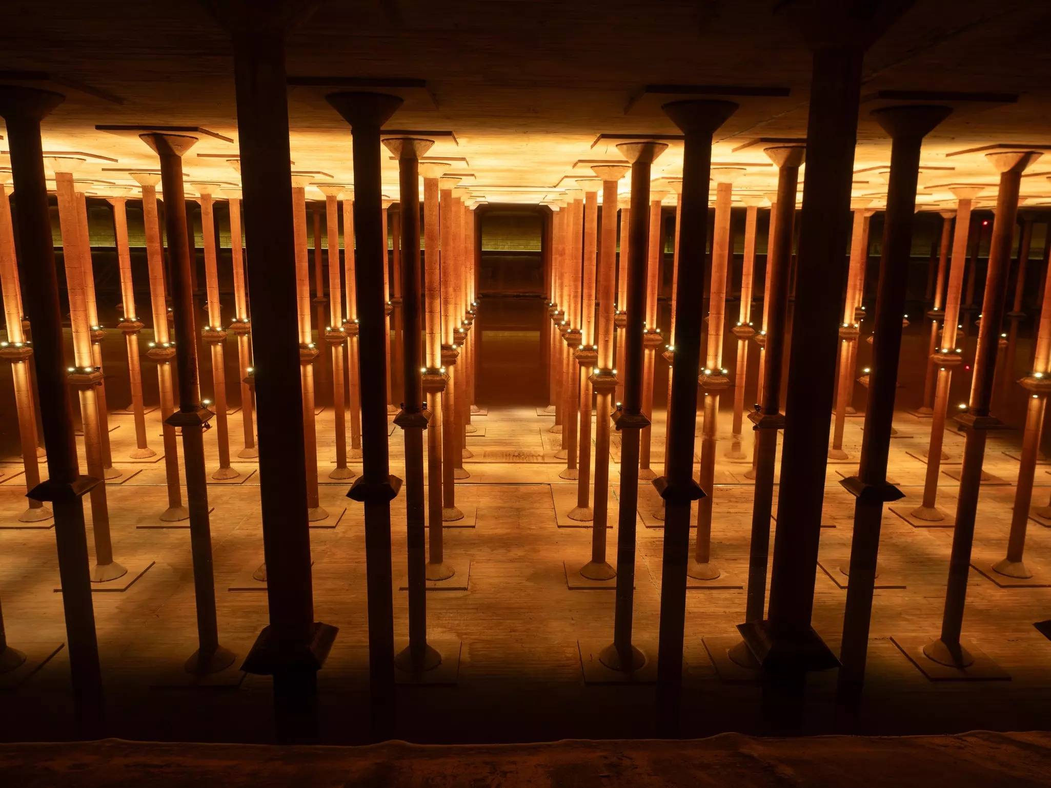 A series of struts and supports linking floor and ceiling in an underground space.