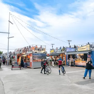 People enjoying Pier 5 food stalls at Dadaocheng Wharf in Taipei, Taiwan on a sunny day.