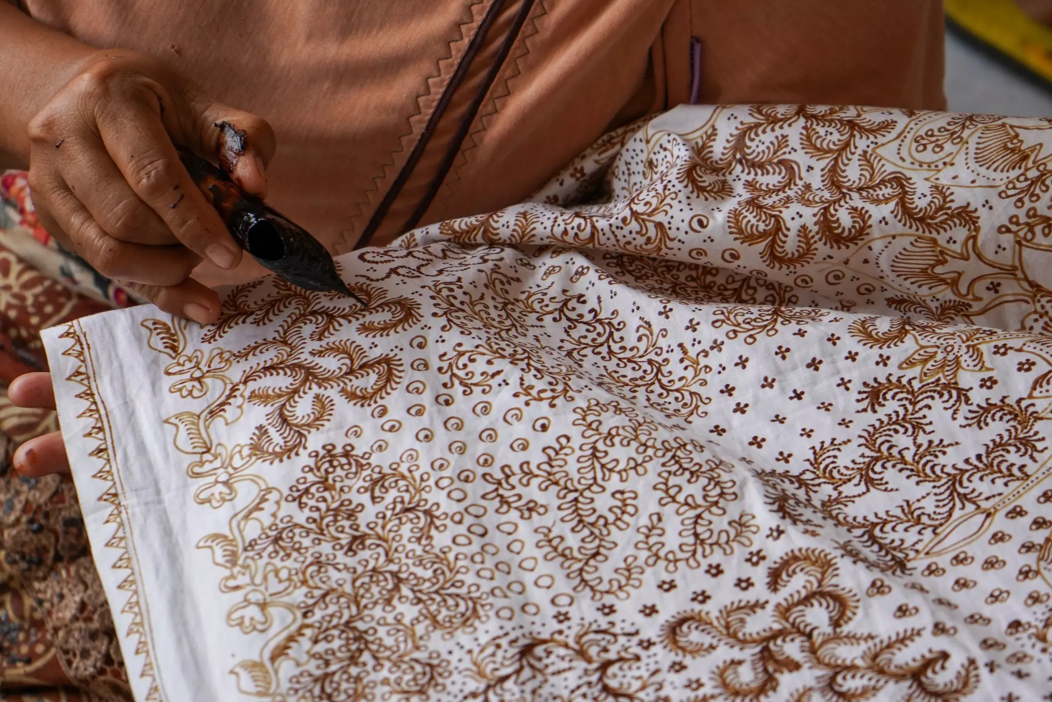 Using wax to create batik designs, an ancient craft in Yogyakarta, Indonesia.