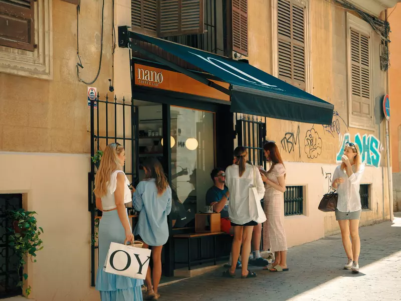 People lined up outside a coffee shop