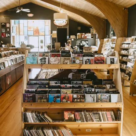 rows of shelves of vinyl inside a record shop