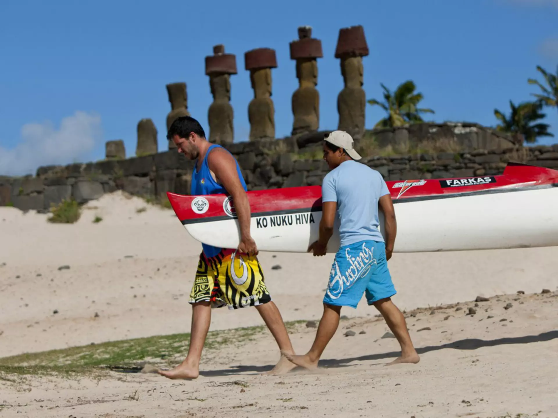 Men carrying kayak on Anakena Beach on Rapa Nui (Easter Island), Chile
