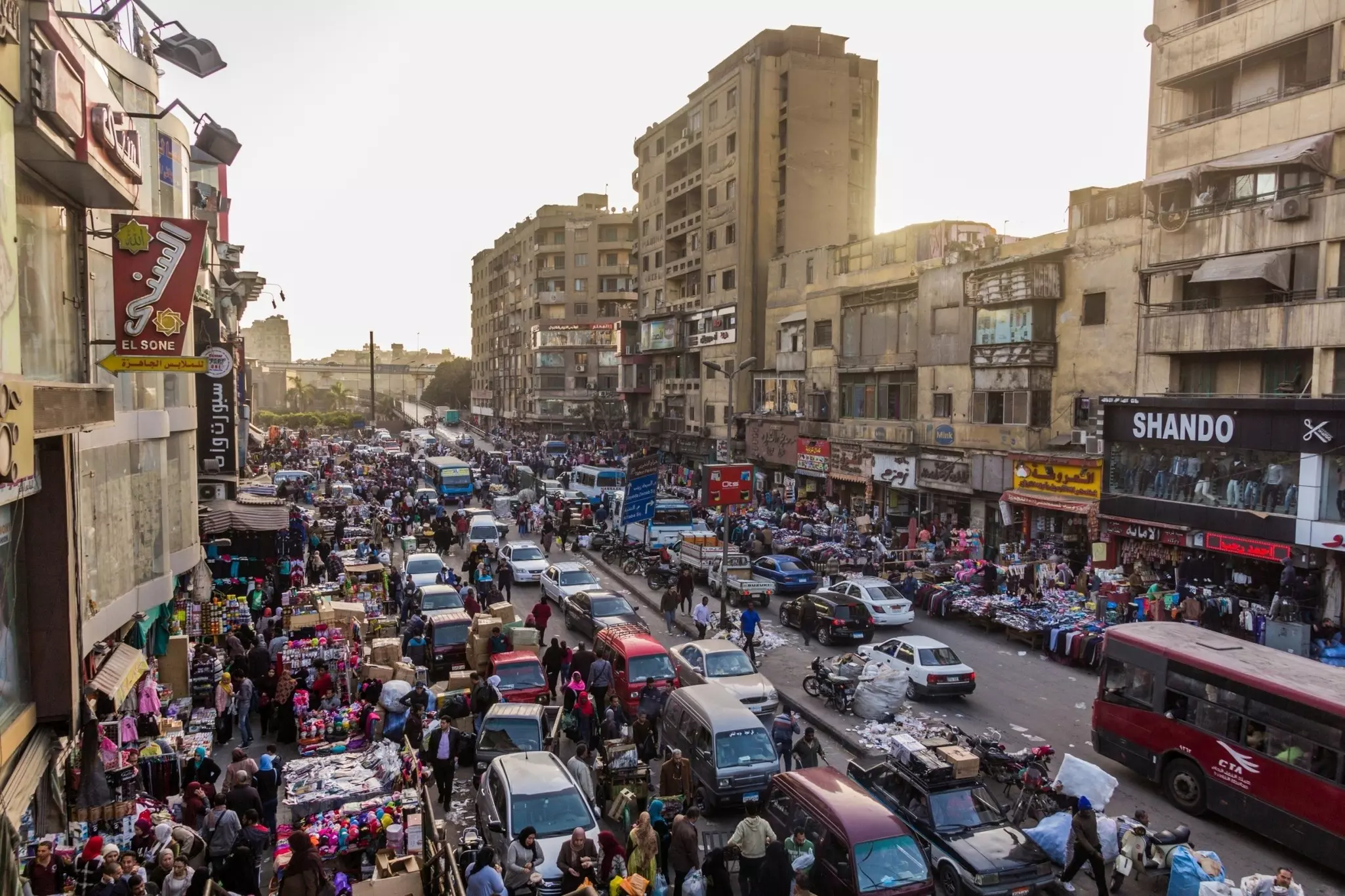 A road packed with vehicles and vendors in Egypt.