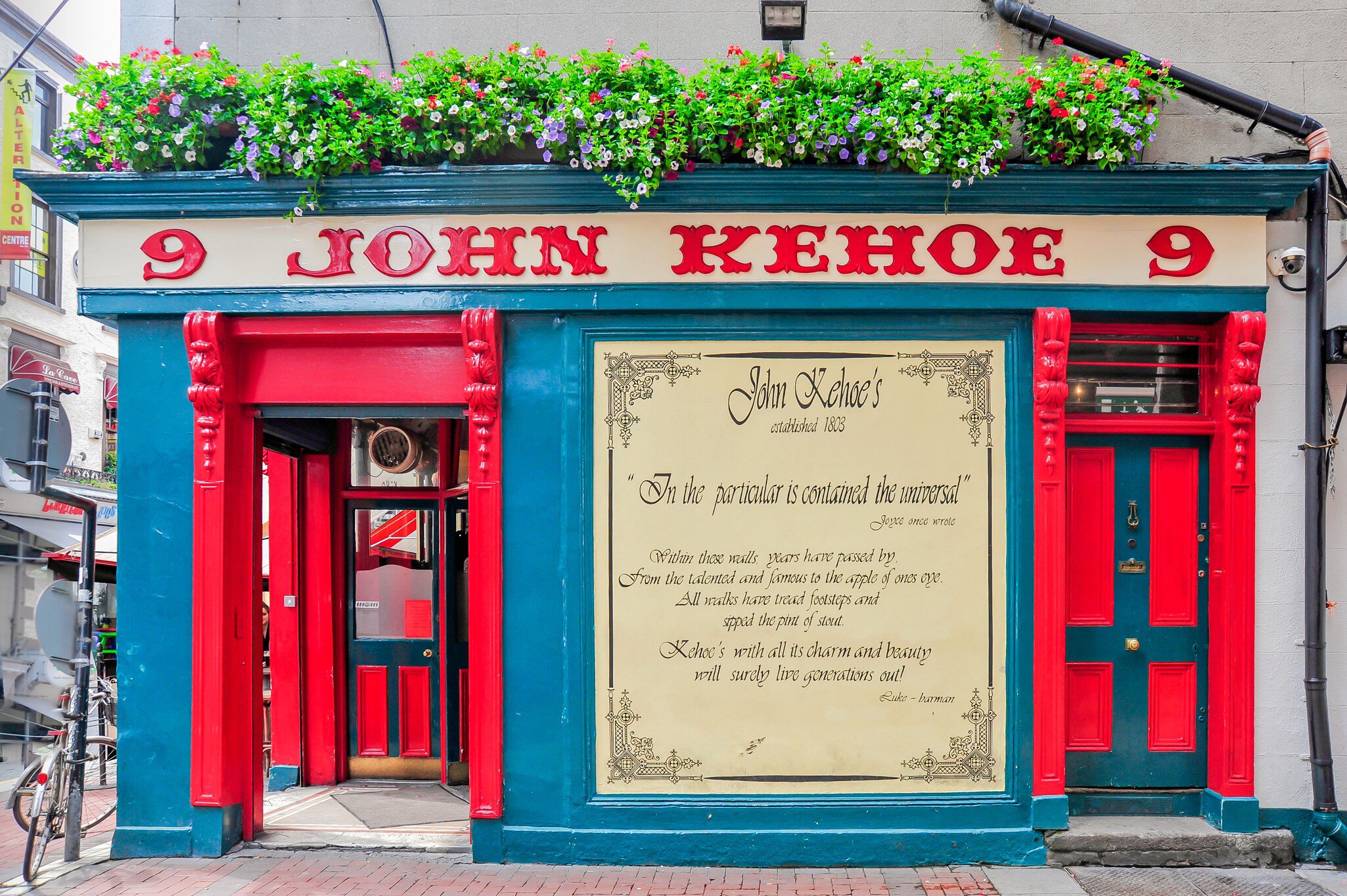 Exterior of Kehoe's pub with flower boxes adorning the shop sign
