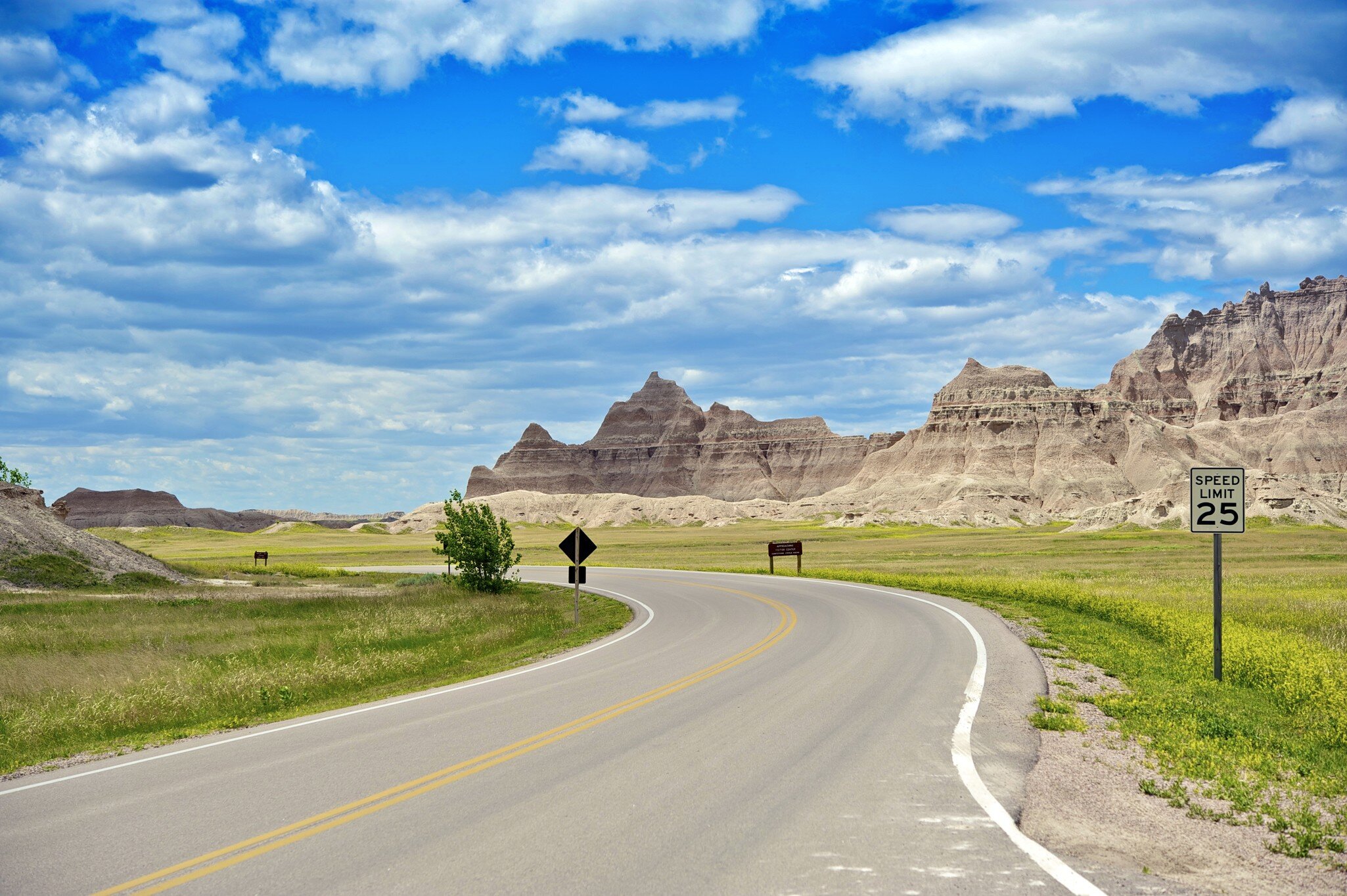 Badlands Loop Road in Badlands National Park in South Dakota, USA. Cloudy Blue Sky - Summer Day. Nature Photo Collection.
