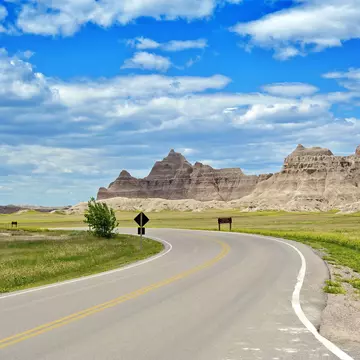 Badlands Loop Road in Badlands National Park in South Dakota, USA. Cloudy Blue Sky - Summer Day. Nature Photo Collection.