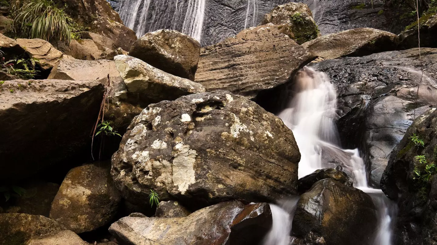 Water cascades off the rocks La Coca Falls in Puerto Rico.