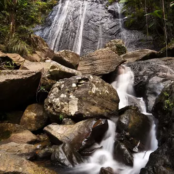 Water cascades off the rocks La Coca Falls in Puerto Rico.