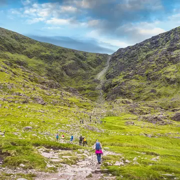 Group of hikers in Cronins Yard starting to climb Devils Ladder to reach the highest mountain in Ireland Carrauntoohil, Ring of Kerry, Ireland  License Type: media  Download Time: 2021-08-06T00:02:52.000Z  User: mvm_lonelyplanet  Is Editorial: No  purchase_order:   
