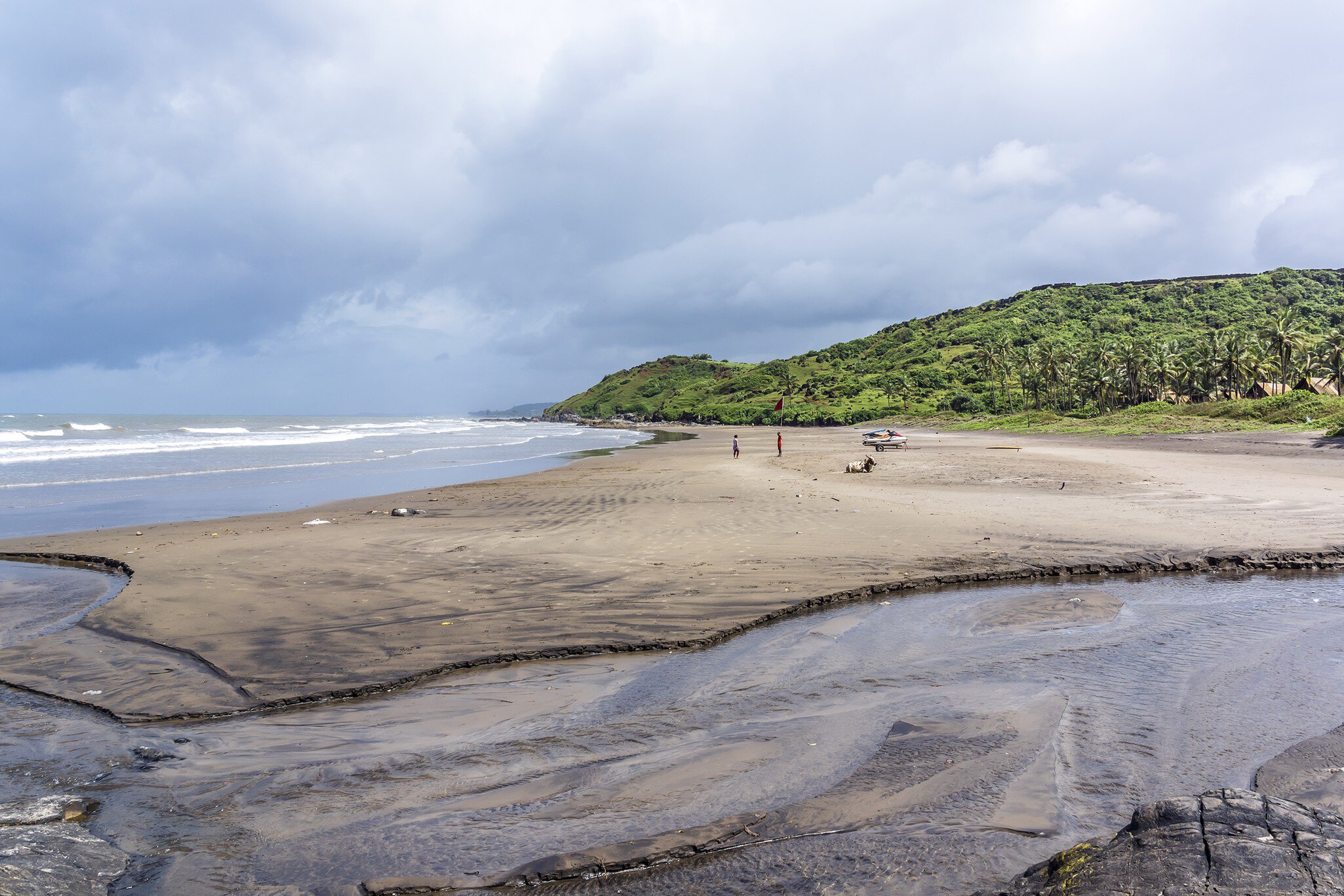 Vagator Beach's red cliffs, Arabian Sea and golden sand, the northernmost beach of Bardez Taluka, Goa, India.