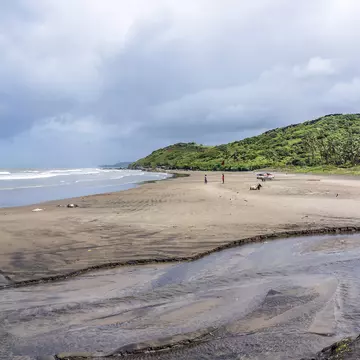 Vagator Beach's red cliffs, Arabian Sea and golden sand, the northernmost beach of Bardez Taluka, Goa, India.