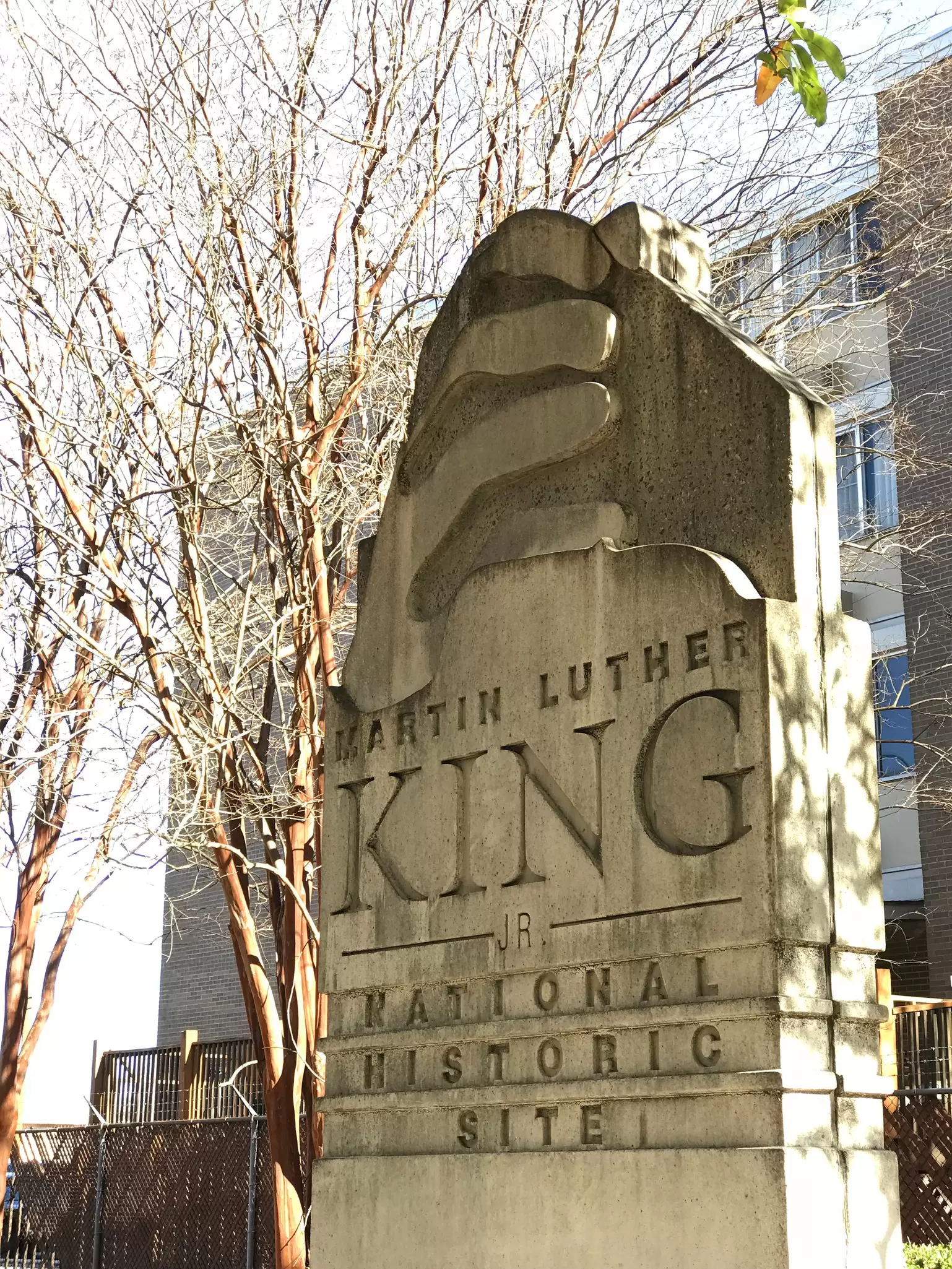 A large white stone marker engraved with "Martin Luther King Jr. National Historic Site"