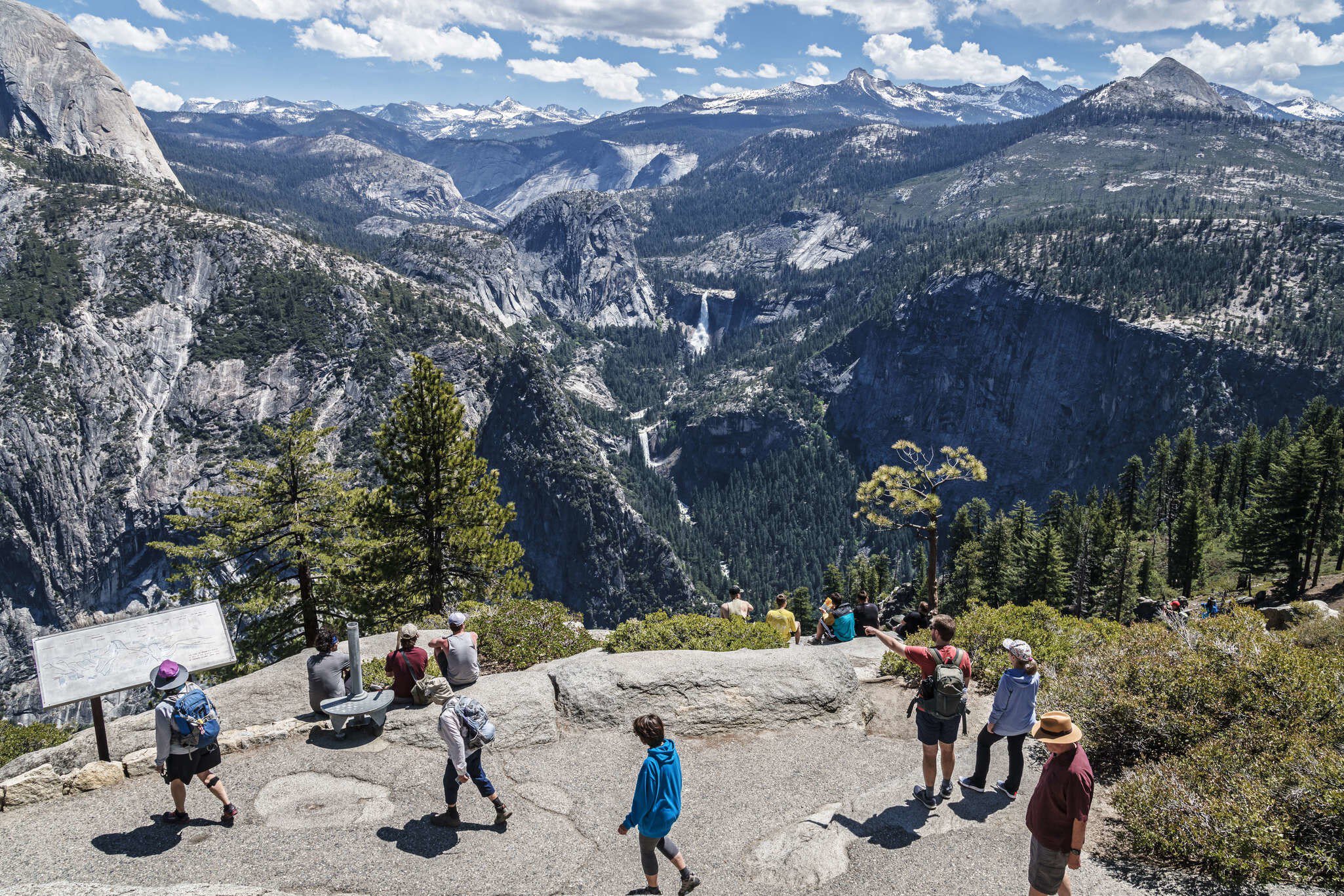 People seen from above, enjoying the view of Nevada and Vernal falls at Glacier Point in Yosemite.