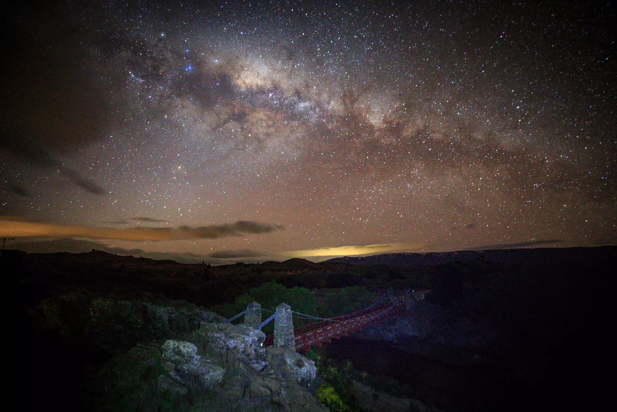 A glow in the sky on the horizon gives way to a galaxy full of stars.