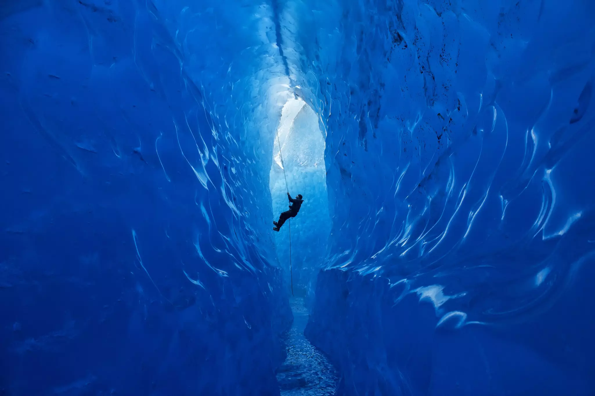 A climber rappels into an ice cave on the Mendenhall Glacier