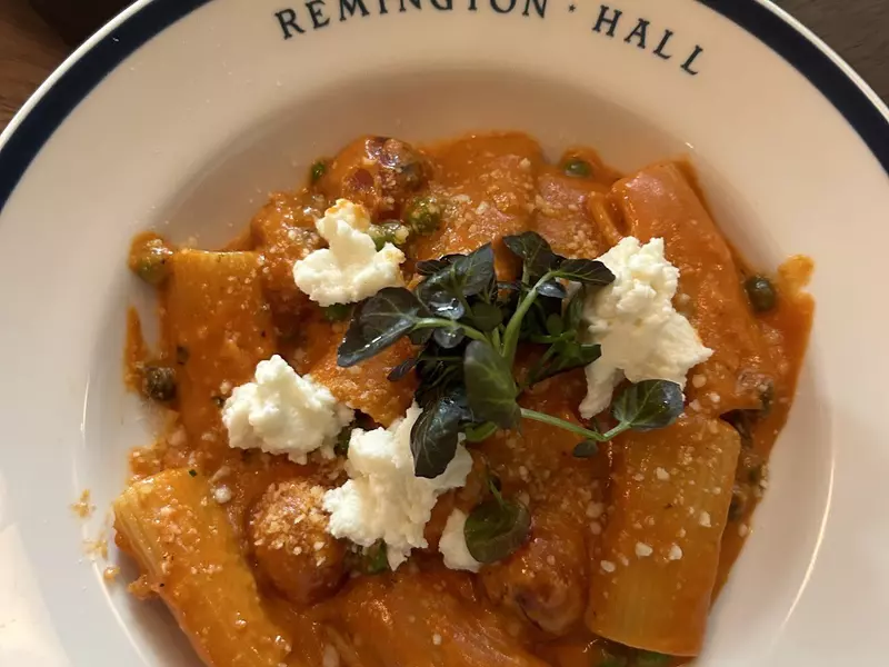 A bowl of pasta with cheese. 
