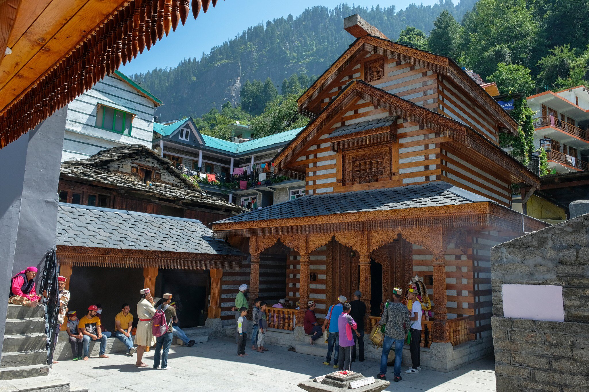 Men making an offering at the Vashishtha temple in Vashisht, Himachal Pradesh, India.