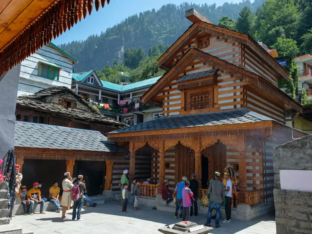 Men making an offering at the Vashishtha temple in Vashisht, Himachal Pradesh, India.