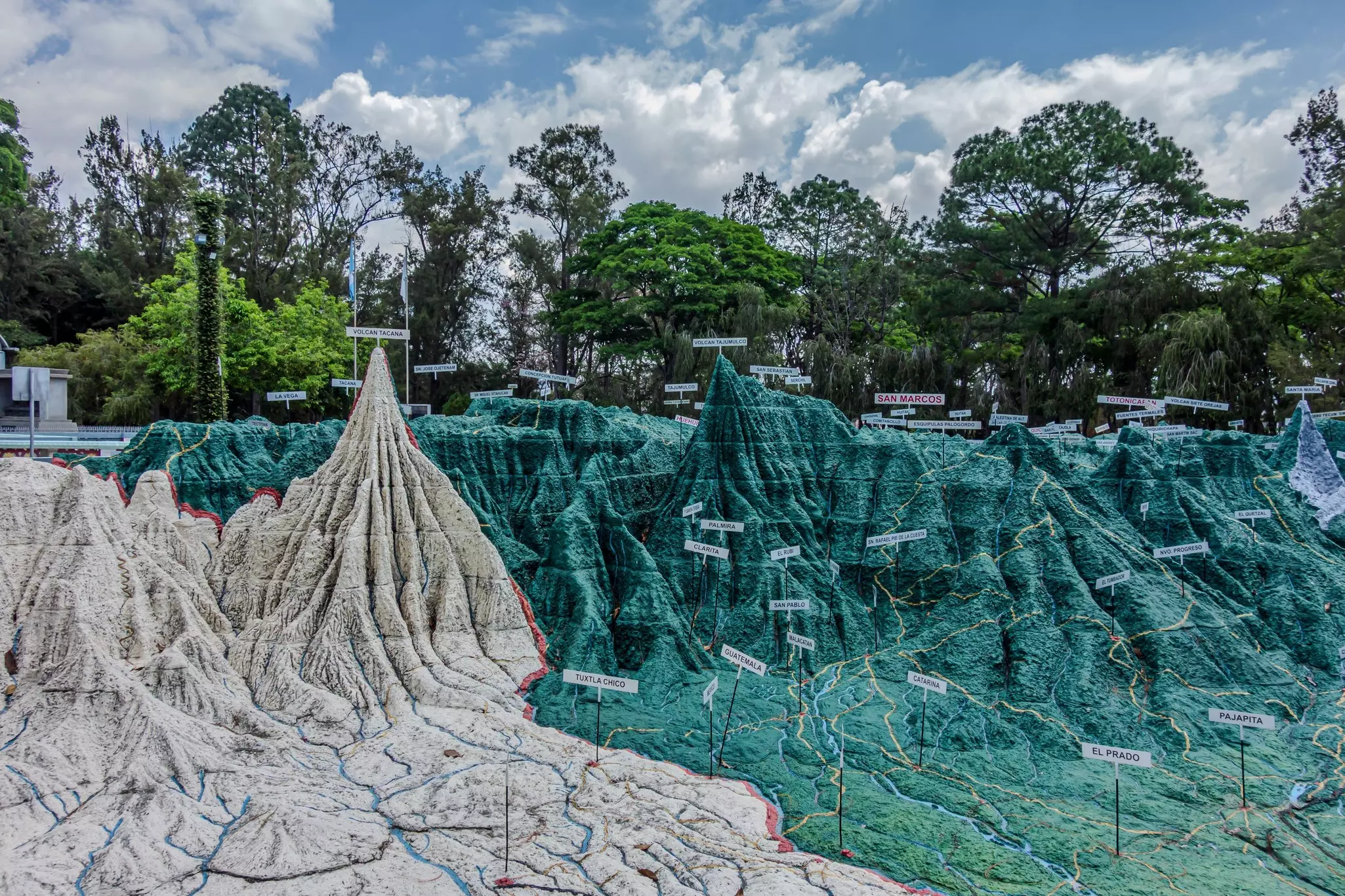 A giant 3D relief map shows the topography of a landscape at scale.