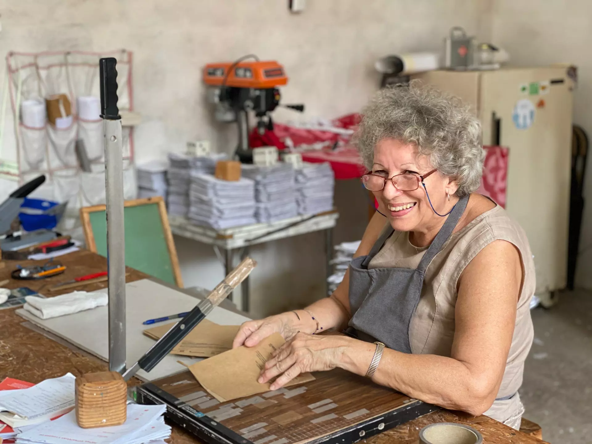 Mary, the mother-in-law of Ciclo's founder, making event programs from recycled paper