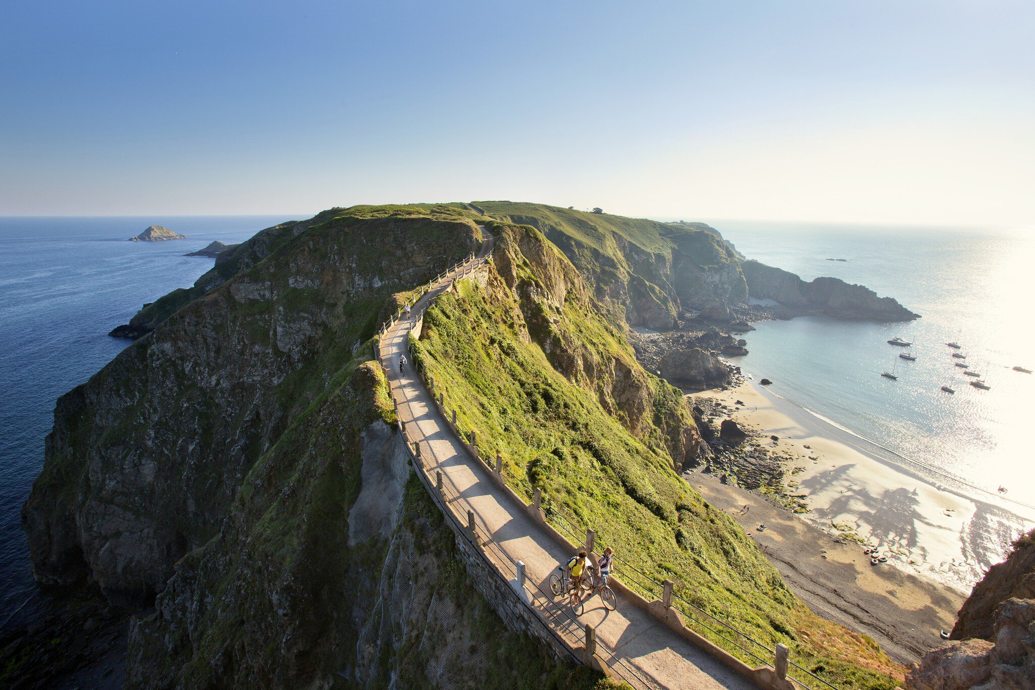 Cyclists on La Coupee; narrow isthmus that connects Big Sark to Little Sark.