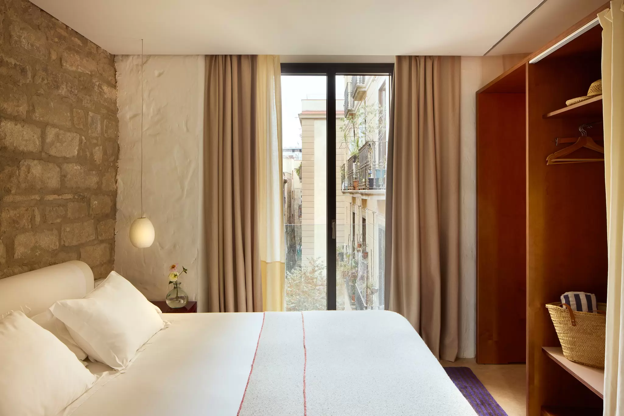 A small hotel room with floor to ceiling windows and a view of the square below: Hotel Neri, Barcelona