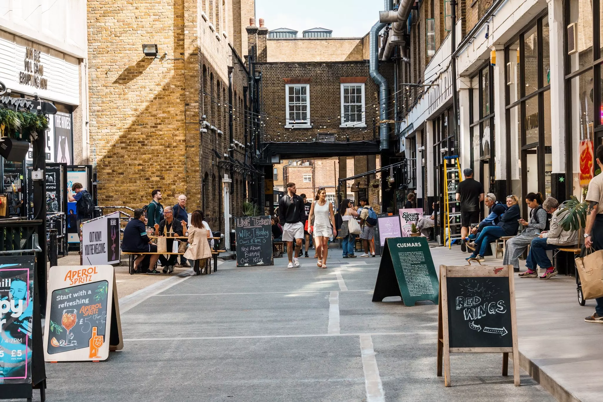 London, UK - August 25, 2023: Street scene with people shopping in Dray Walk, a pedestrian street near Brick Lane in Shoreditch Area in the East End, License Type: media, Download Time: 2025-07-22T16:42:25.000Z, User: adouglaslott59, Editorial: true, purchase_order: 65050 - Digital Destinations and Articles, job: Online editorial, client: London neighborhoods article update, other: Ann Douglas Lott