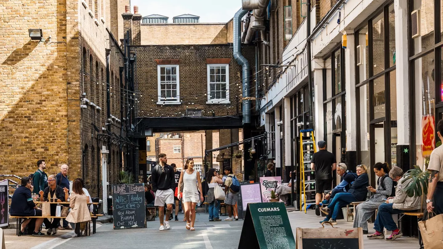 Street scene with people shopping in Dray Walk, a pedestrian street near Brick Lane in Shoreditch Area in the East End