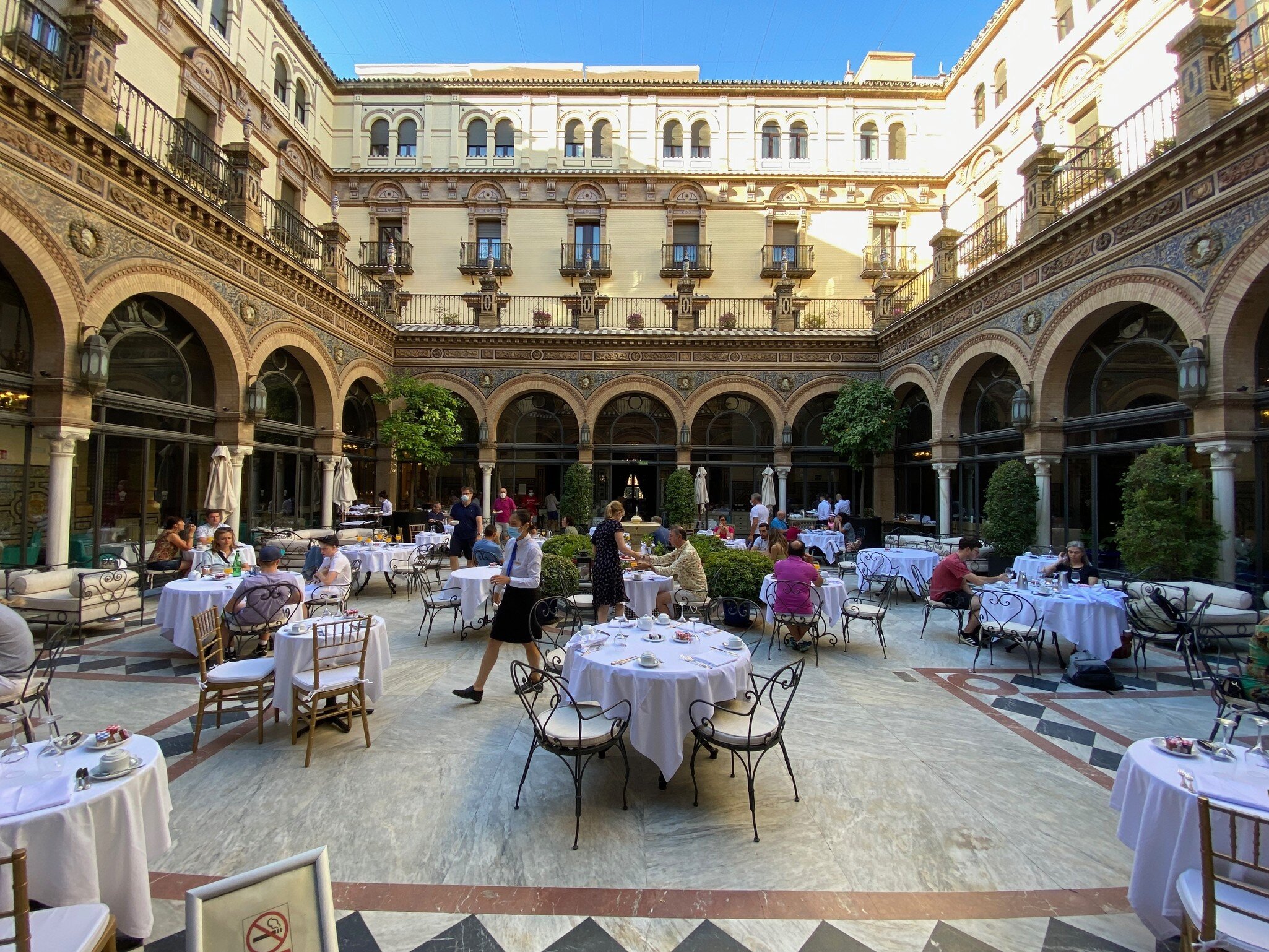 Seville, Spain - April 20 2018: Breakfast tables in the interior courtyard of the historical Hotel Alfonso XIII, a Luxury Collection Hote